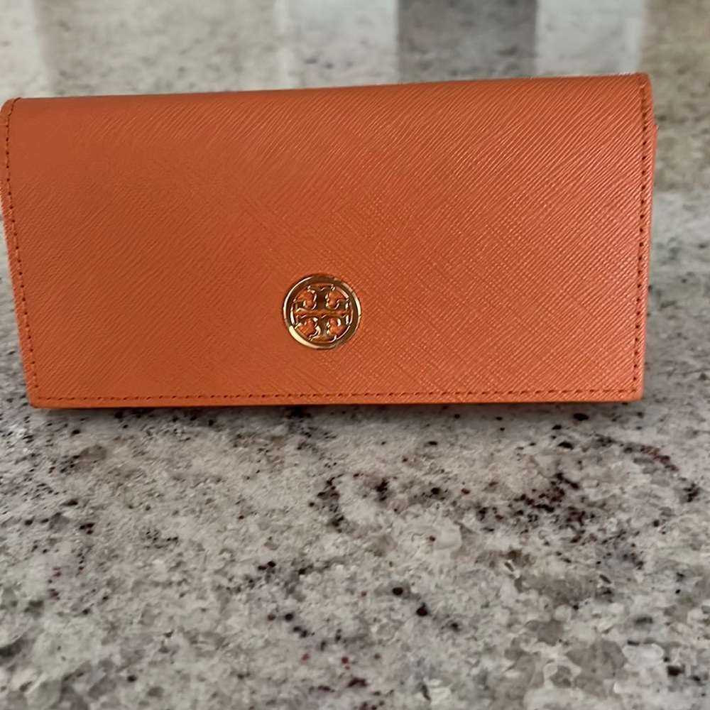Tory Burch Sunglasses + Case with branding on each side of the glasses.